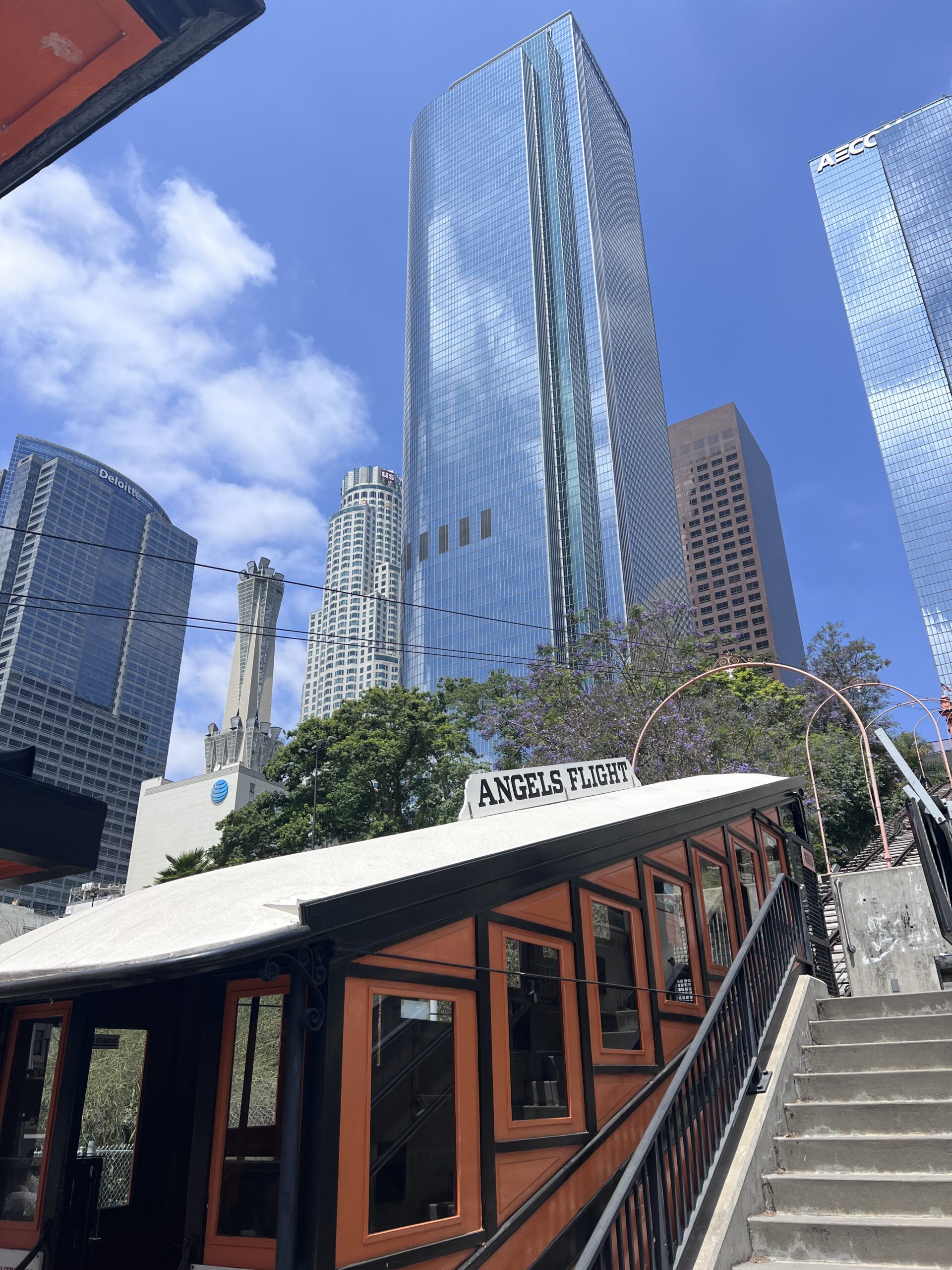 a train traveling past a tall building