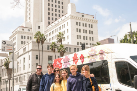 a group of people standing on a sidewalk